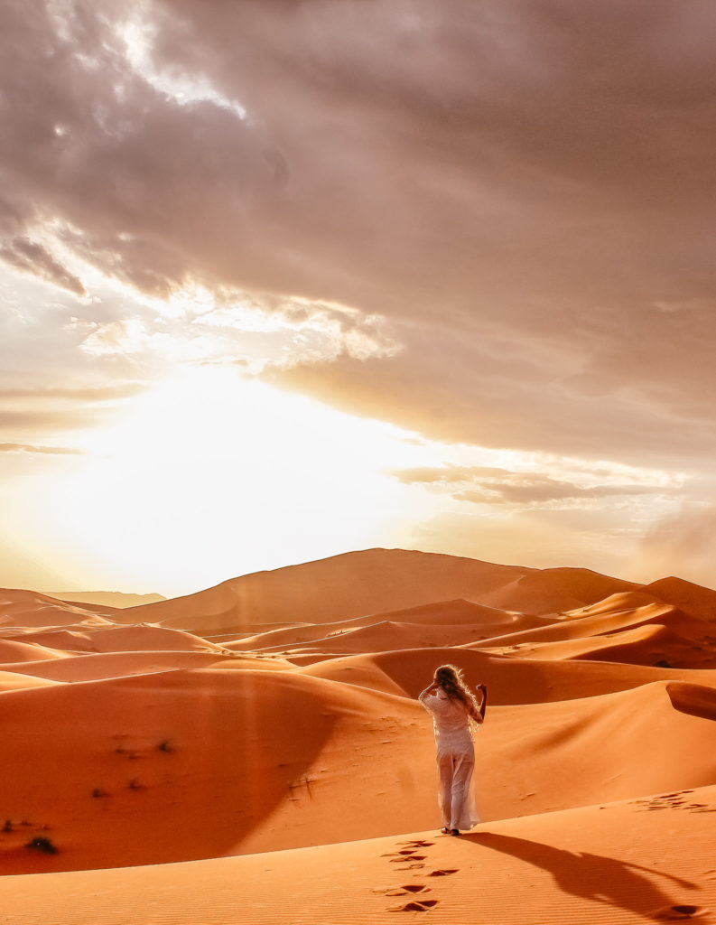 Erg Chebbi Morocco near Merzouga girl standing in white in dunes