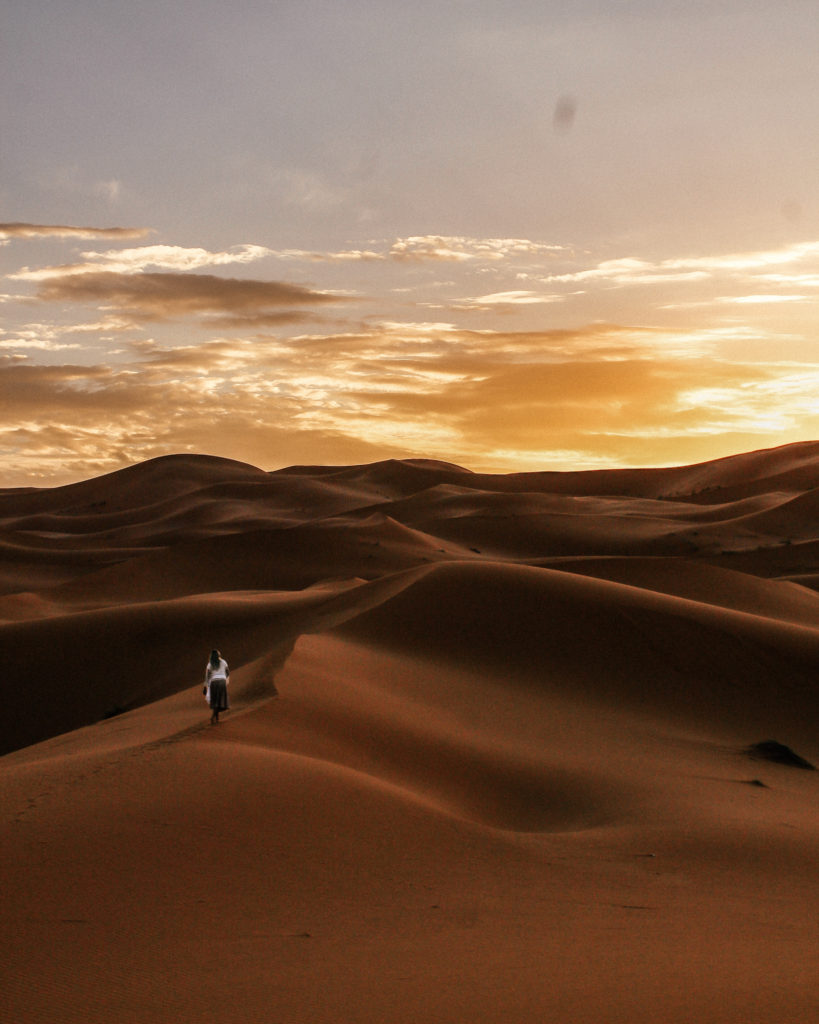 girl standing sand dunes sahara desert