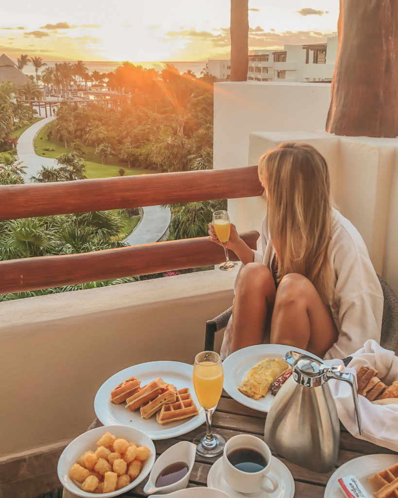 travel planner watching the sunrise with a full breakfast